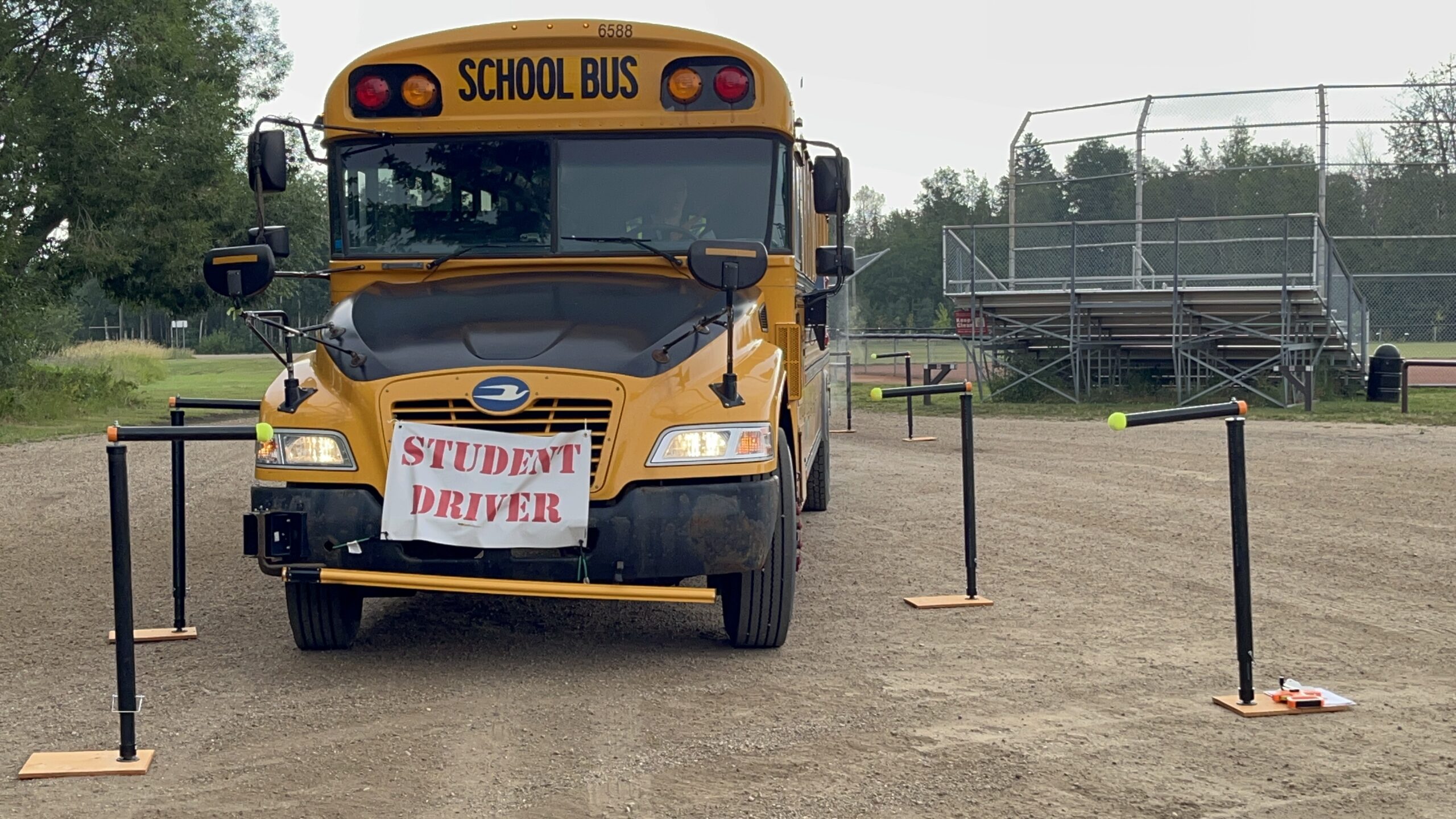 School bus with "student driver" sign on the front of the bus.