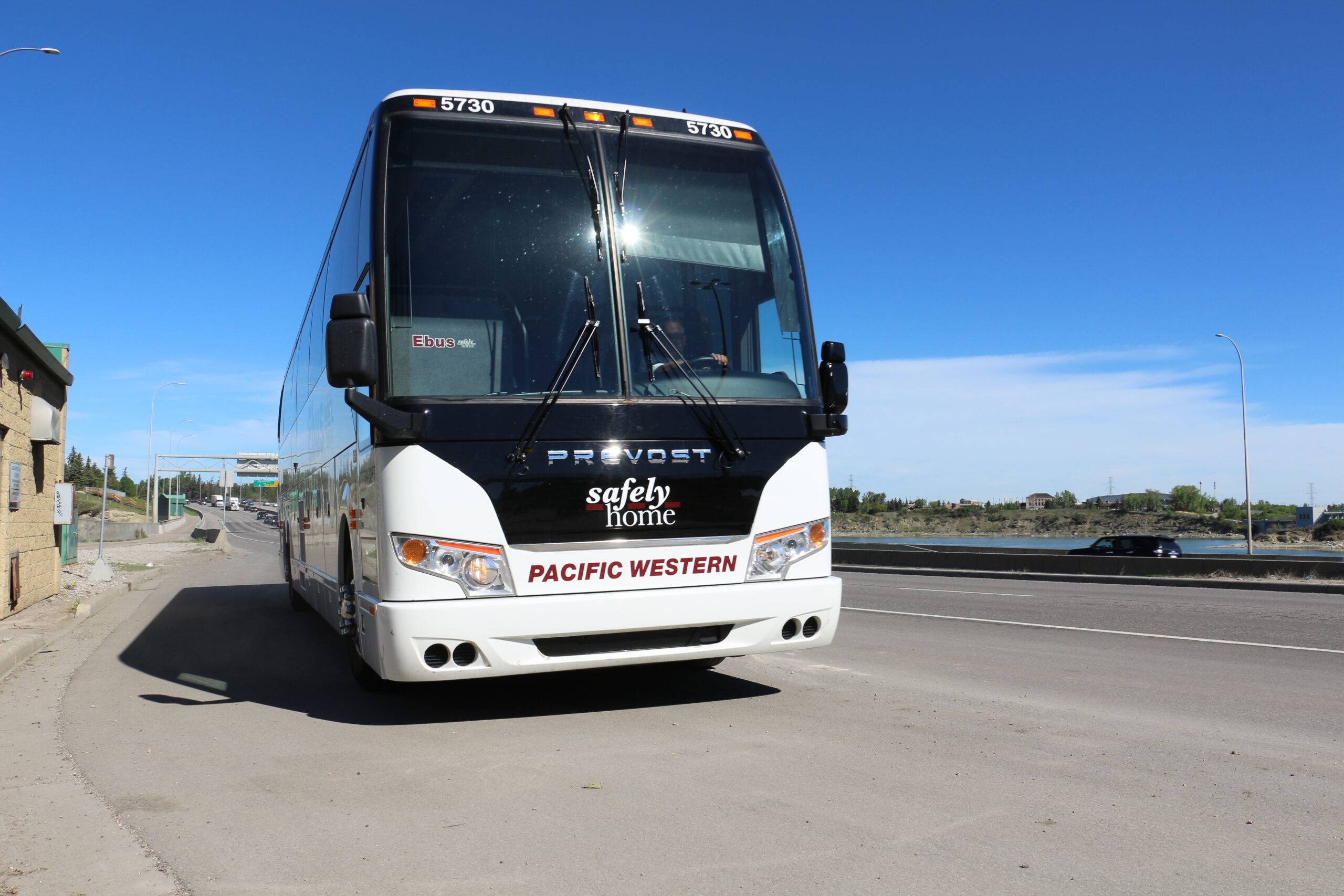 Motorcoach bus driving on road.